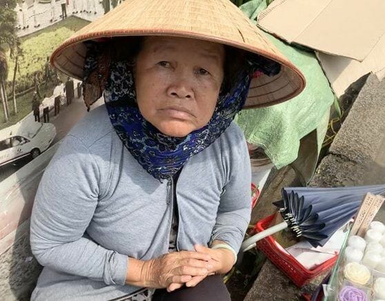 Vietnamese lady selling Catholic gifts in Ho Chi Minh